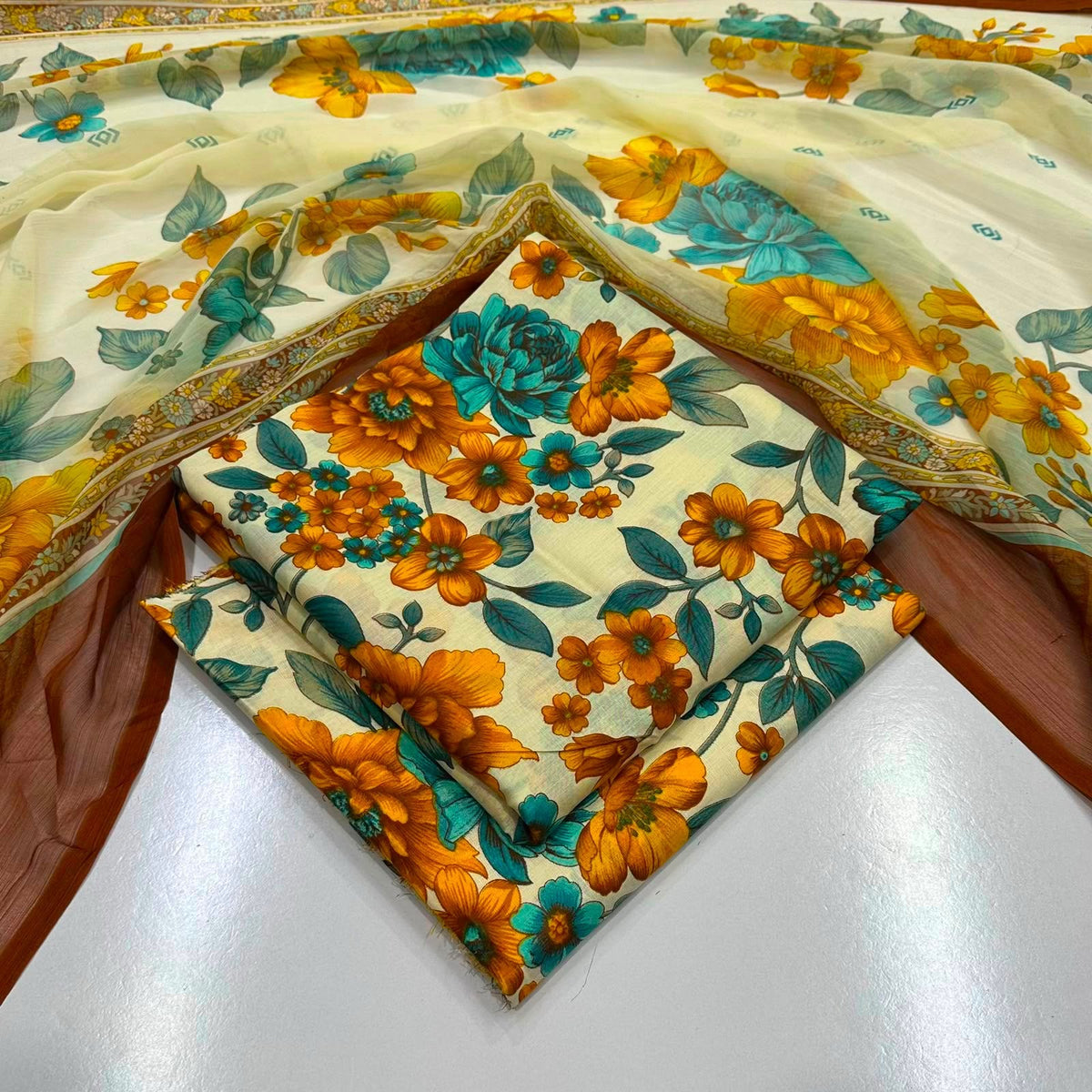 lawn 3 piece suit featuring orange and yellow flowers with teal-blue leaves 