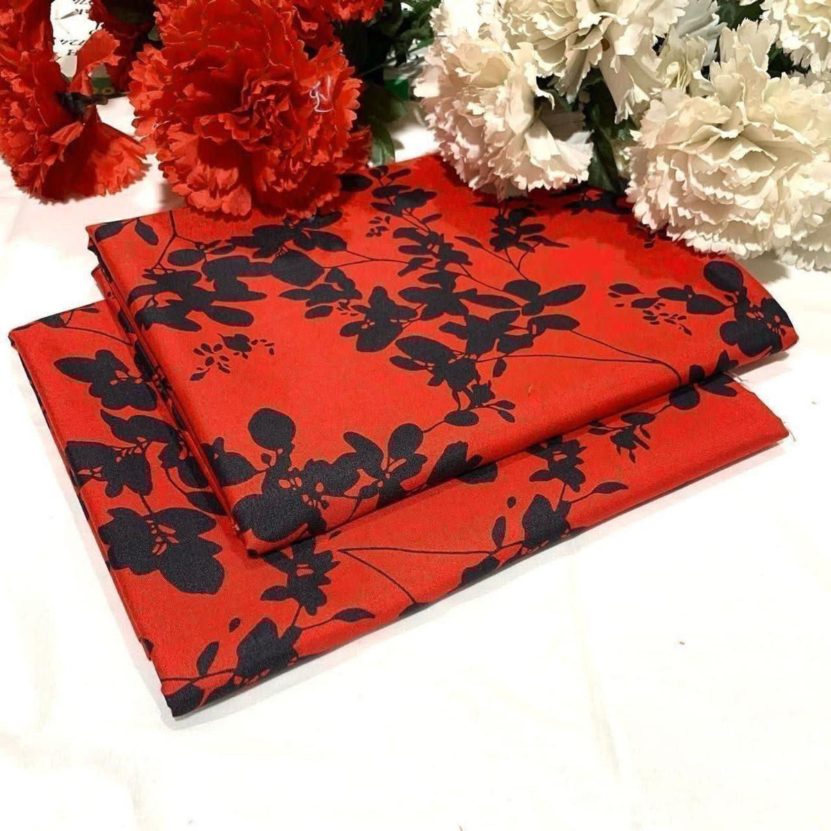2 piece suit in red featuring a black floral silhouette pattern