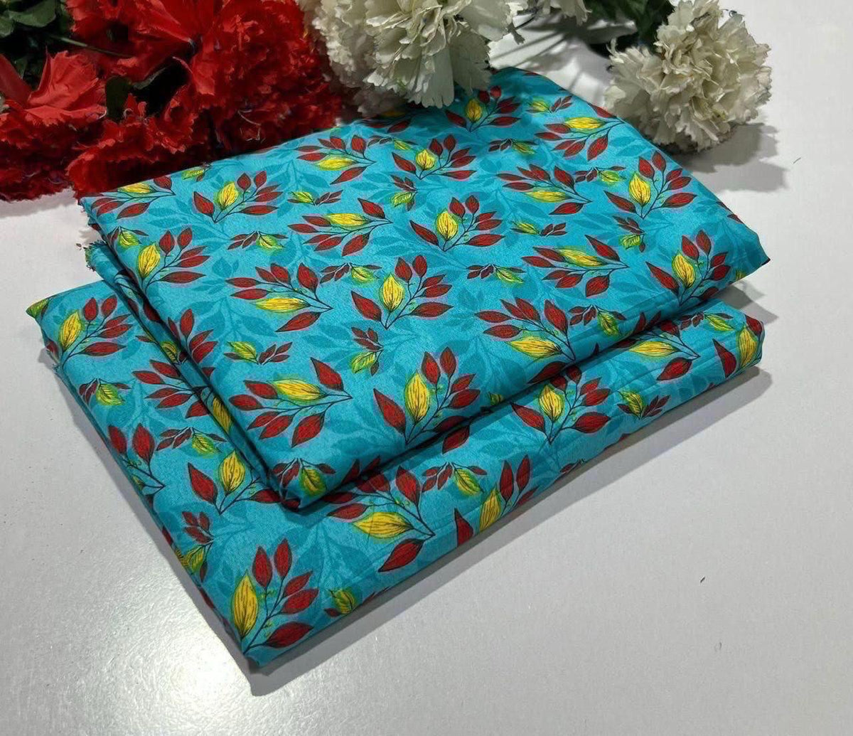 2 piece suit in Turquoise with red and yellow leaf pattern