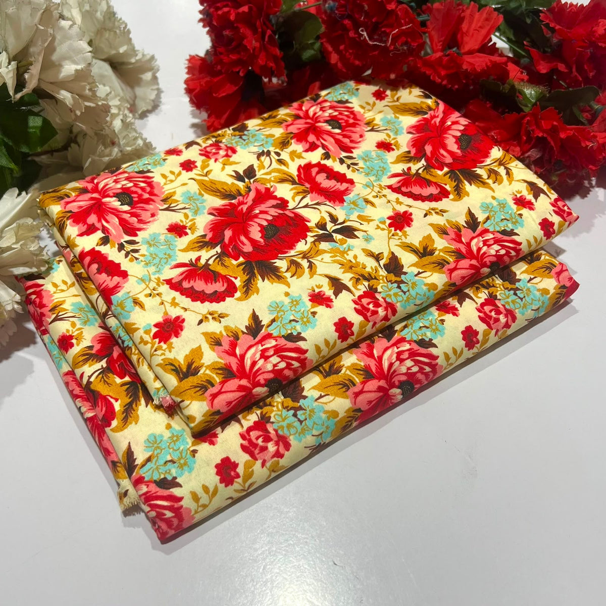 2 piece suit in cream with a vintage floral print in red, teal, and olive green
