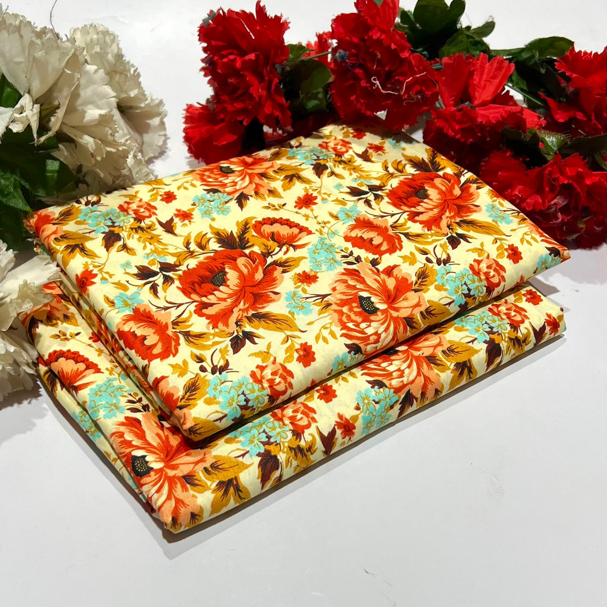 2 piece suit in cream with floral pattern of orange, red, and teal flowers