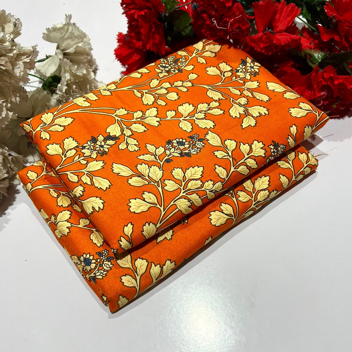 2 piece suit in orange featuring a cream and dark blue floral vine pattern