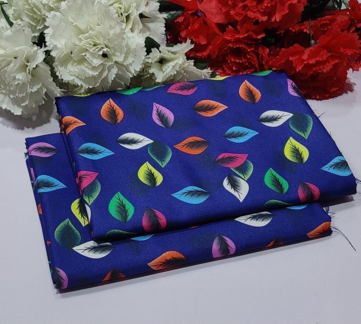 2 piece suit in royal blue fabric with a colorful pattern of stylized leaves