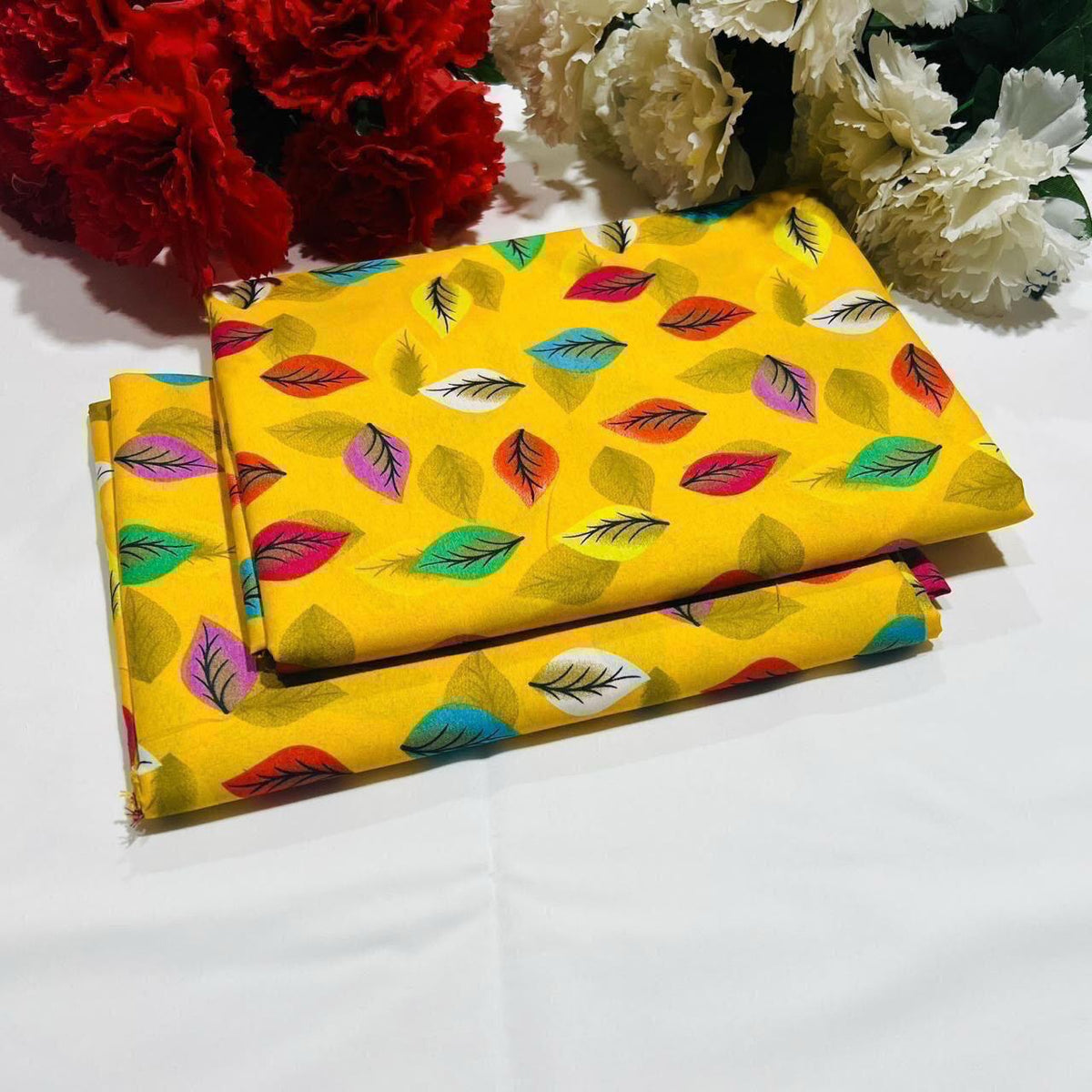 2 piece suit in Yellow with colorful leaf pattern on a white background