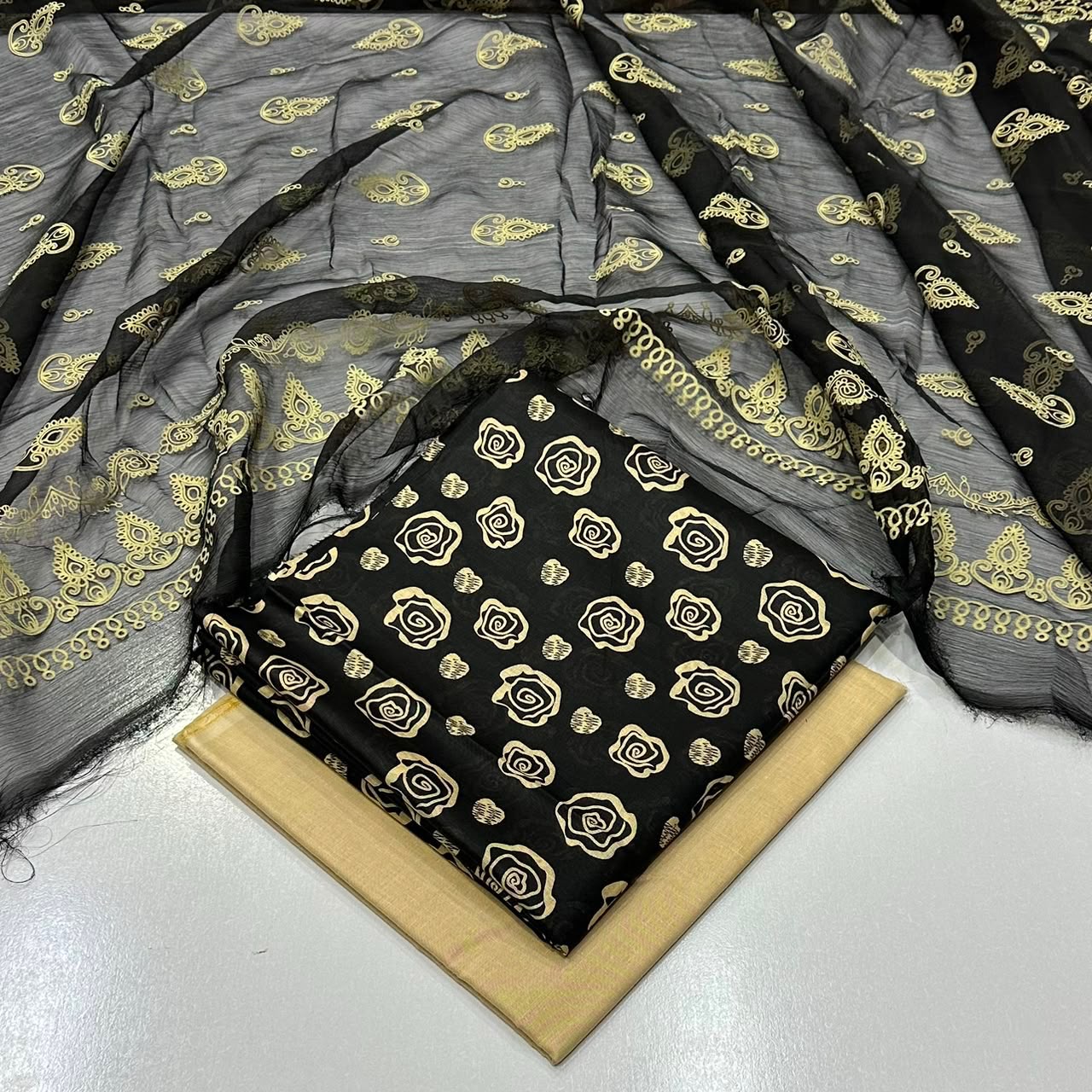 lawn 3 piece suit in Black with a gold rose pattern with a matching sheer black dupatta