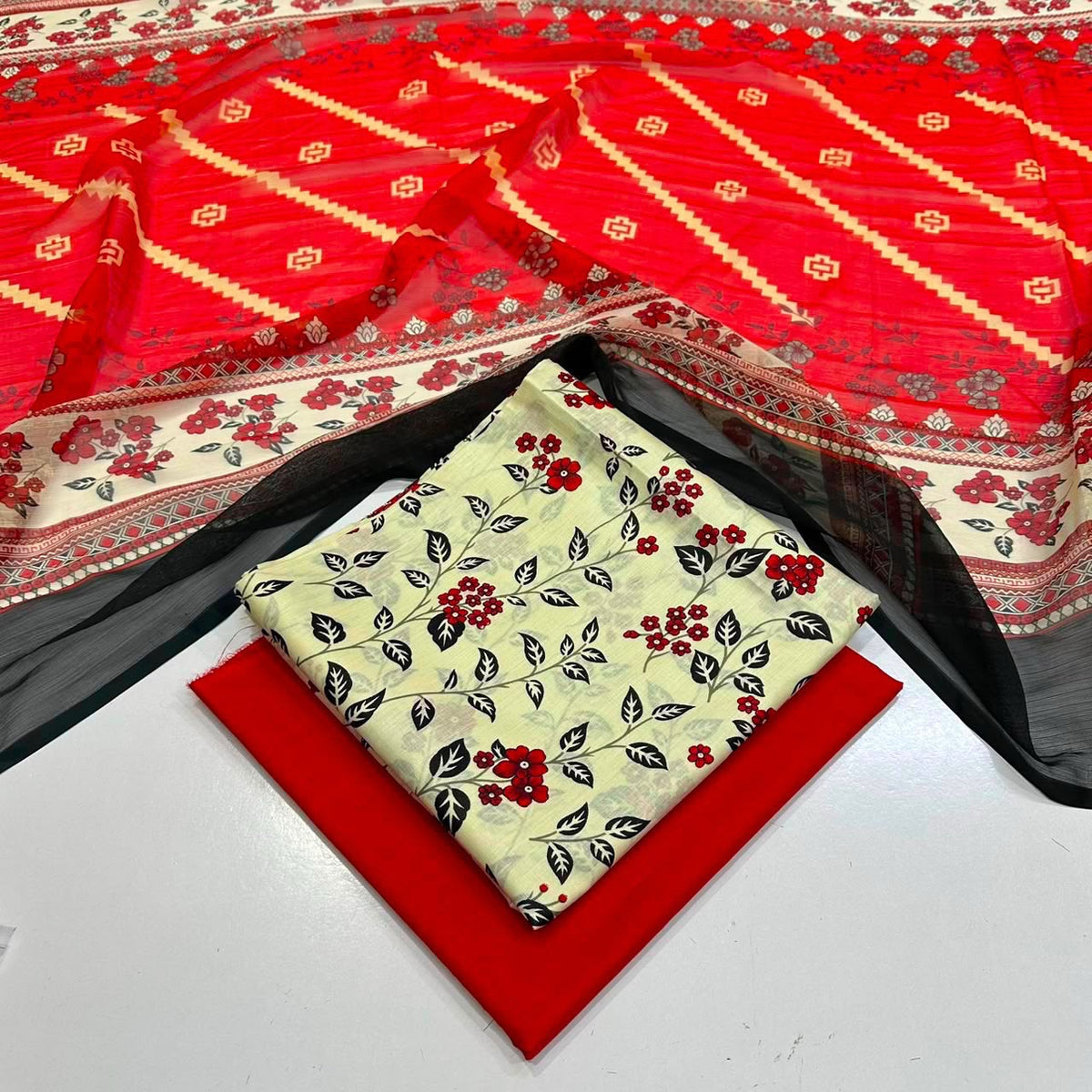 lawn 3 piece suit in red and offwhite and a black red dupatta 