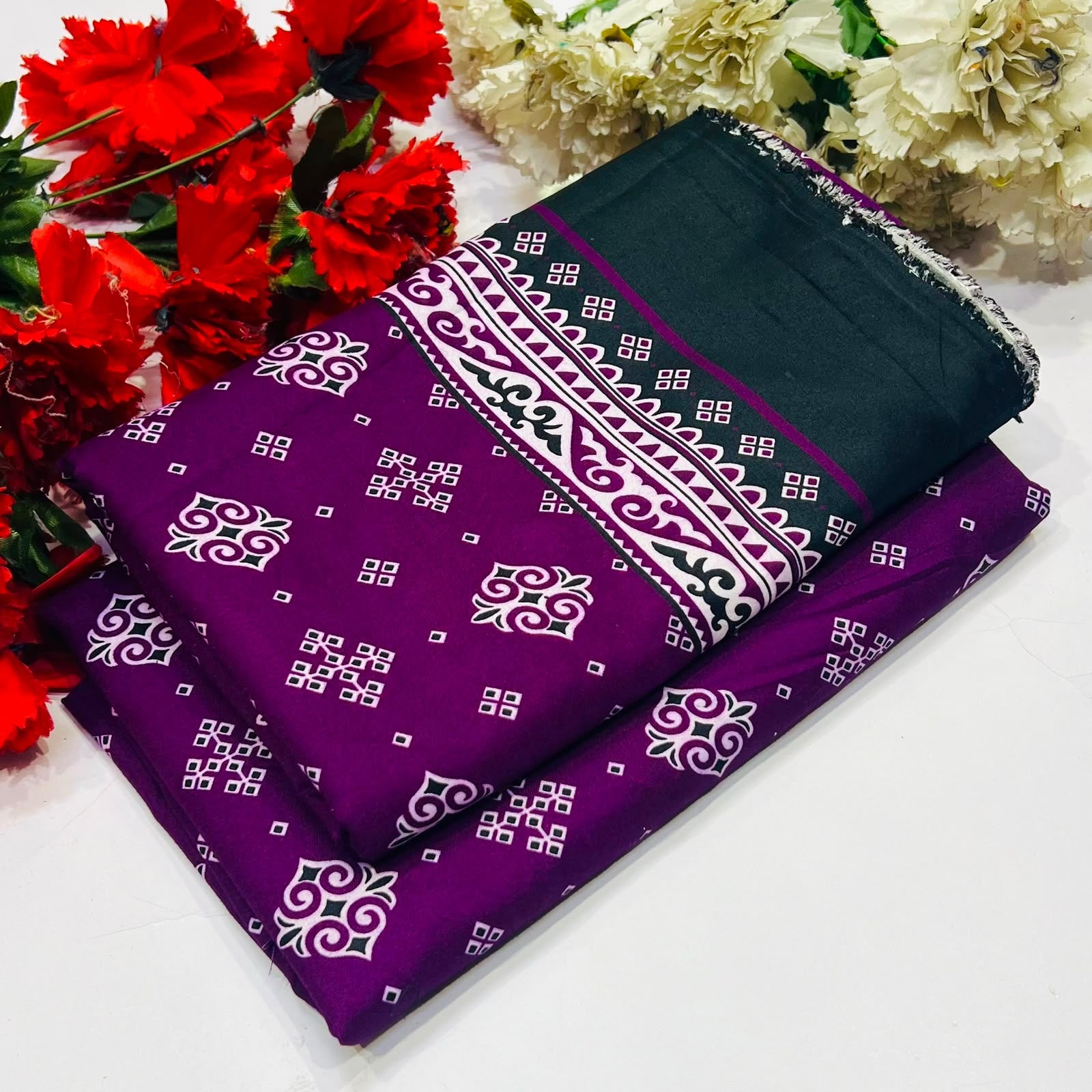  2 piece suit in purple and black with white geometric and floral patterns