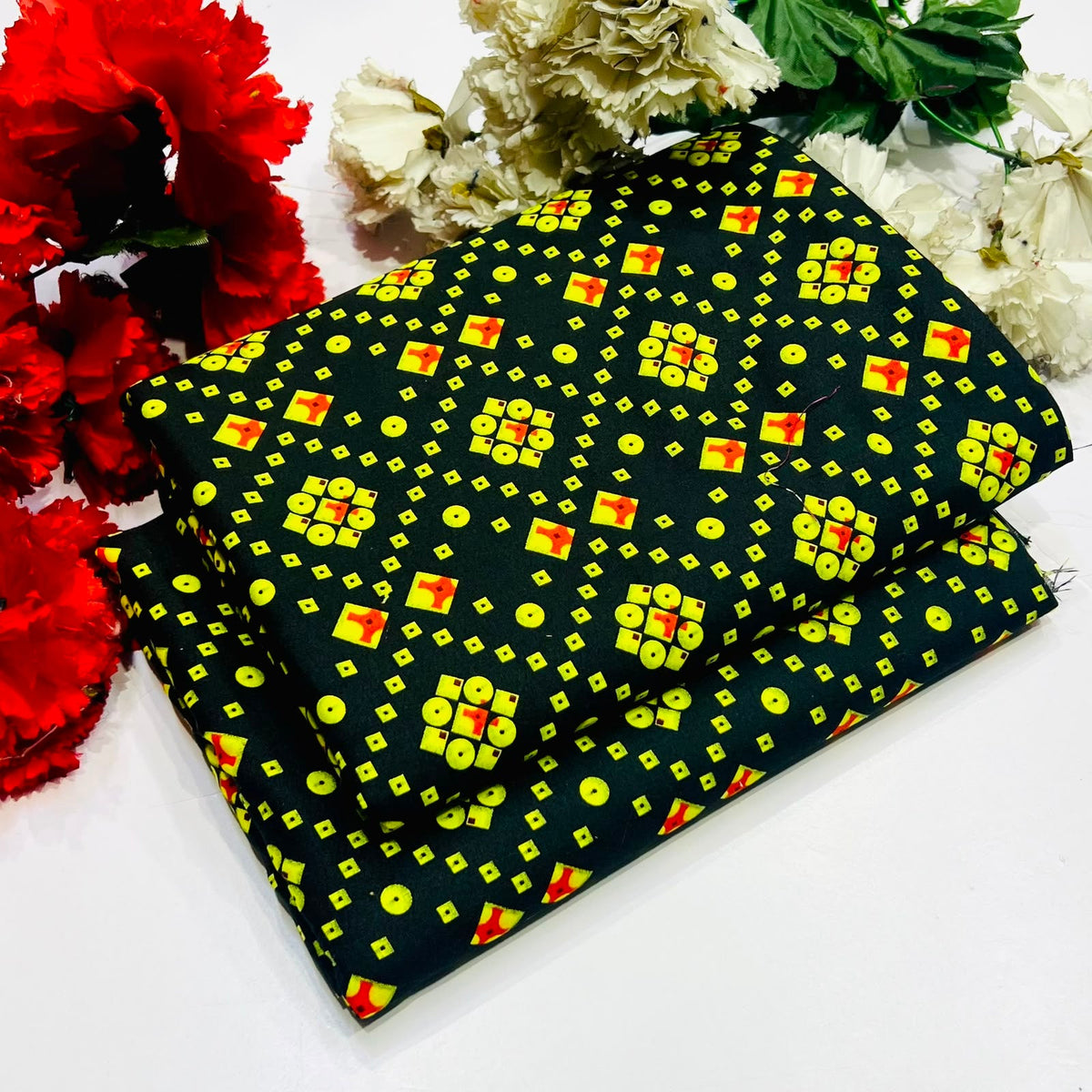 2 piece suit in black  with a vibrant yellow, red, and green geometric pattern
