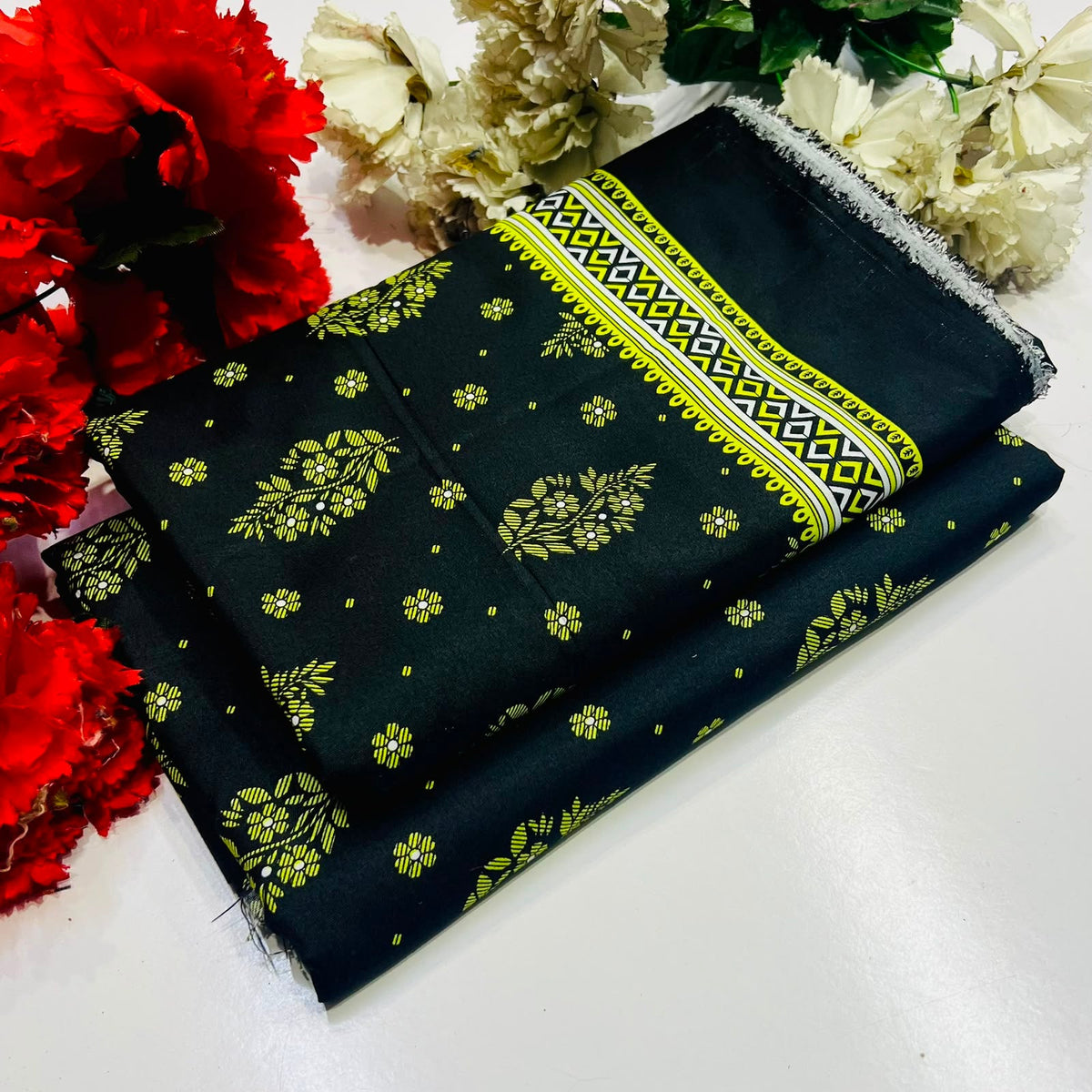 2 piece suit in black with a yellow and green floral pattern 