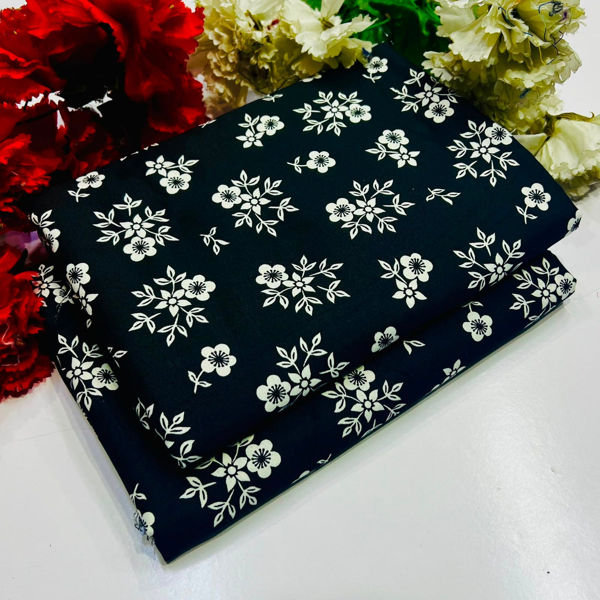 2 piece suit in black featuring a white floral and leaf pattern