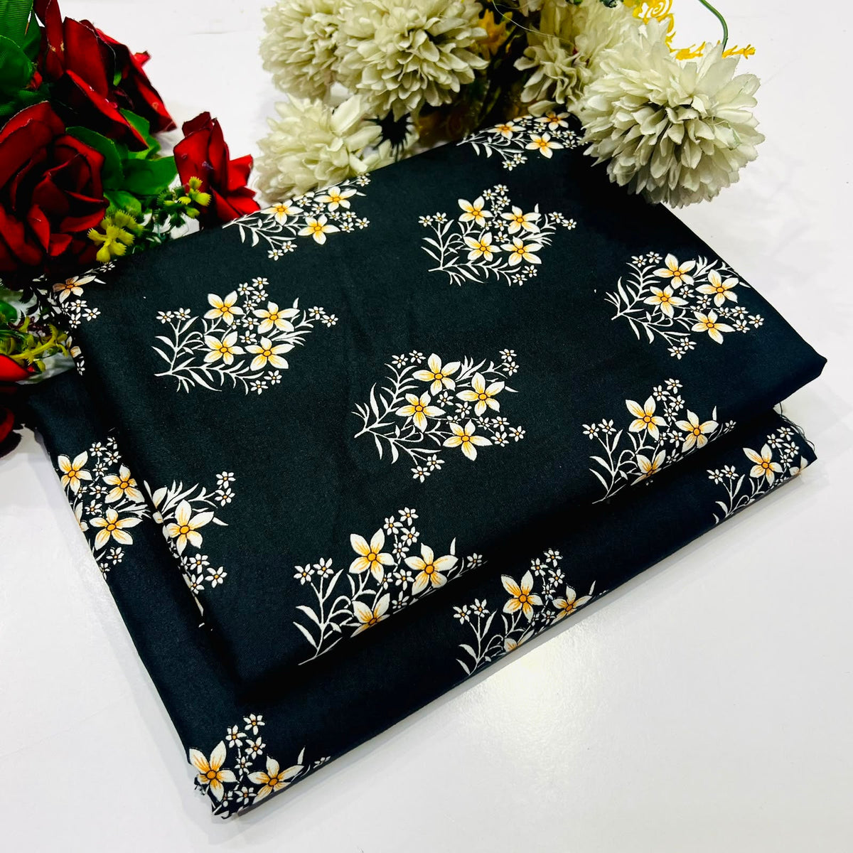 2 piece suit in black color featuring a repeating white and yellow floral pattern