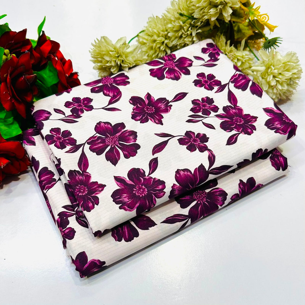 2 piece suit featuring a bold purple floral pattern with white base