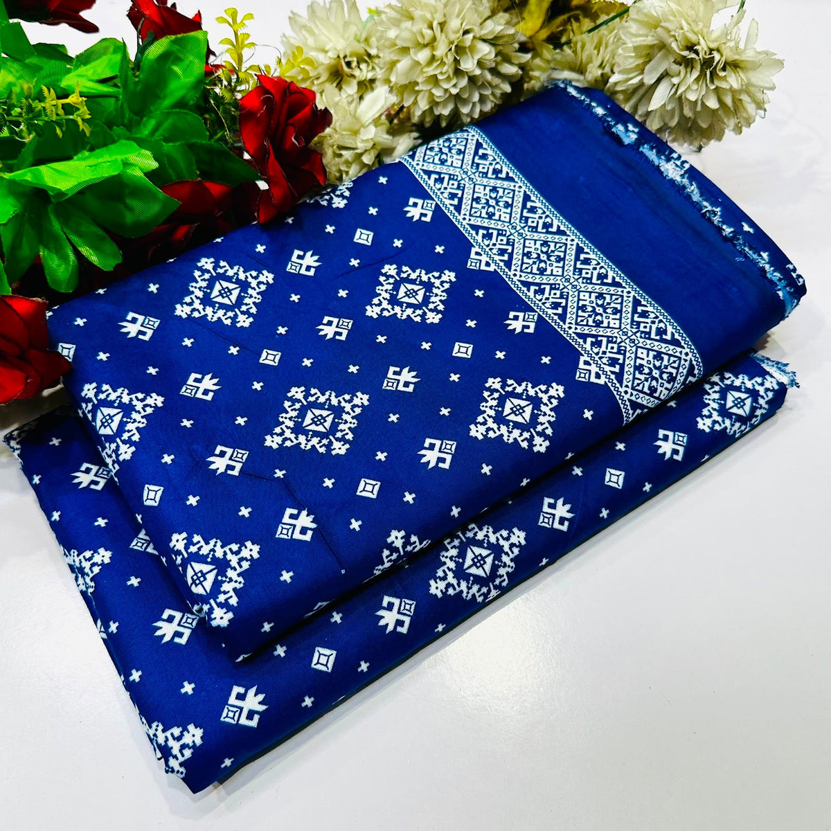 2 piece suit in blue  with a white geometric and floral pattern