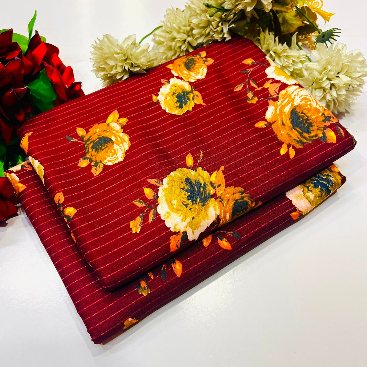 2 piece suit in deep red  with thin vertical white pinstripes and a large yellow floral print
