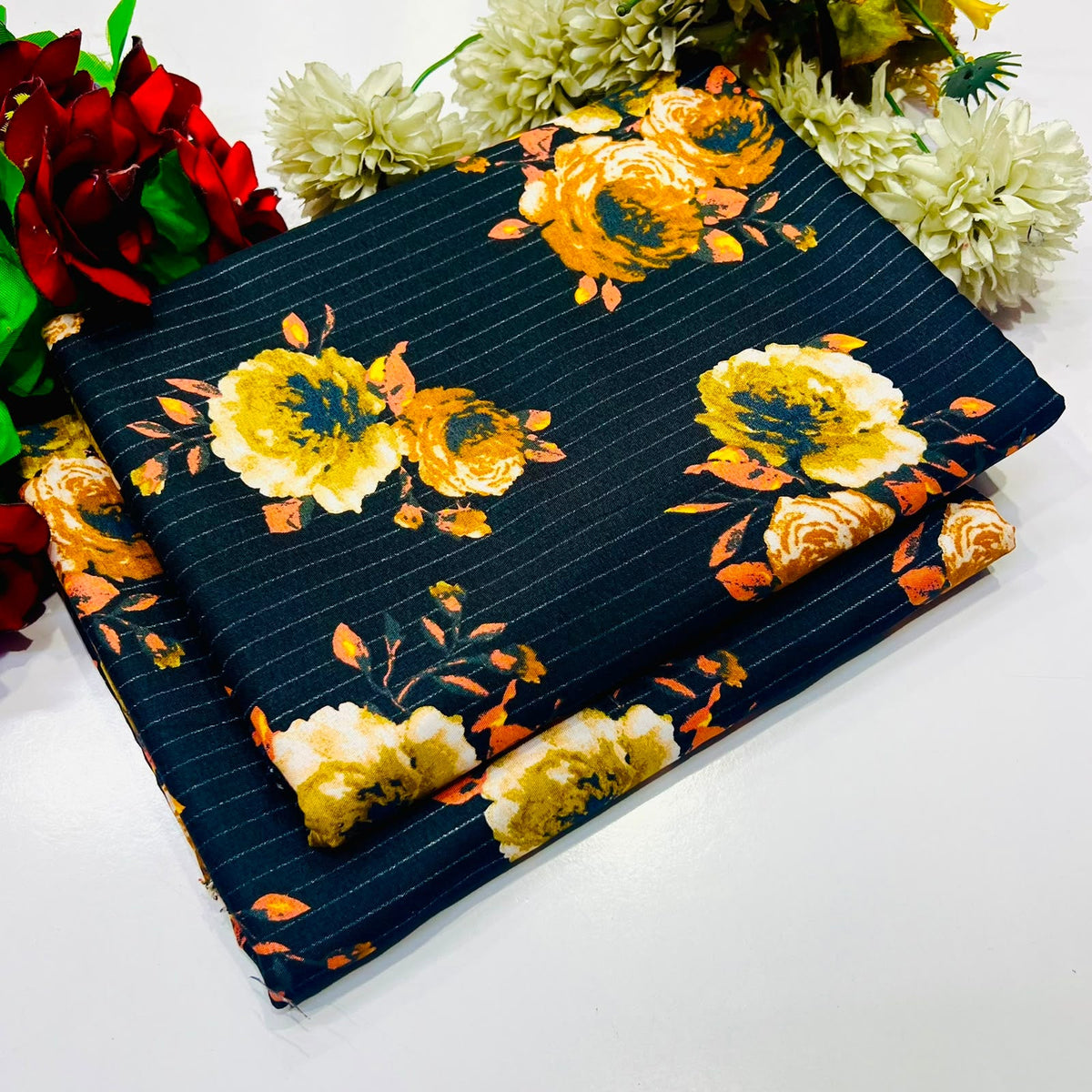 2 piece suit in dark navy blue with thin white pinstripes and a large yellow, orange floral print.