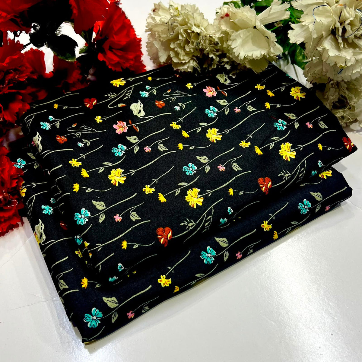 2 piece suit in black with a colorful floral vine pattern