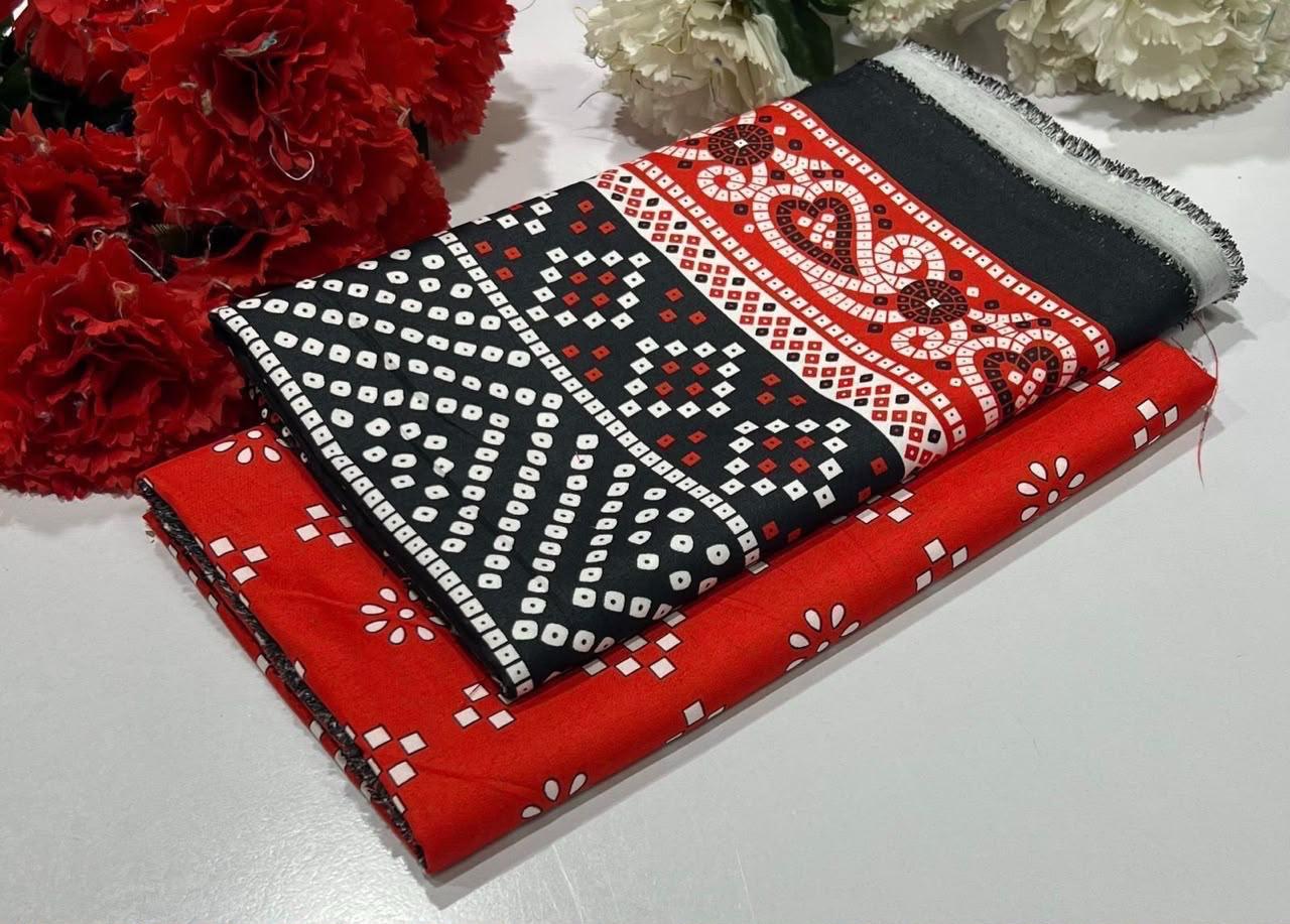 Ladies 2 piece suit in red and black textile designs featuring white motifs and decorative bands